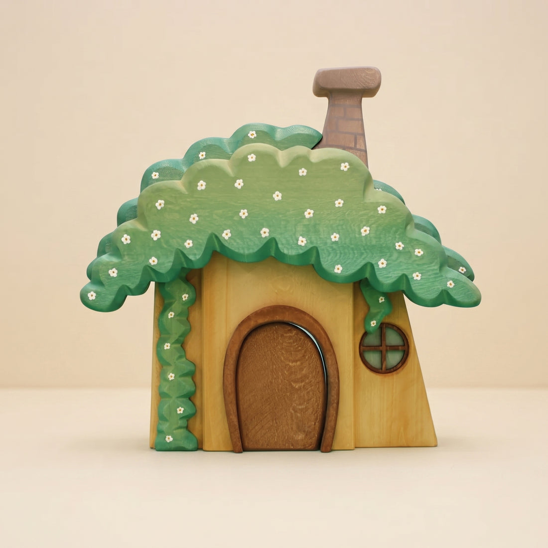 Wooden dwarf's house with a mossy green roof, white flowers, a rounded door, and a chimney