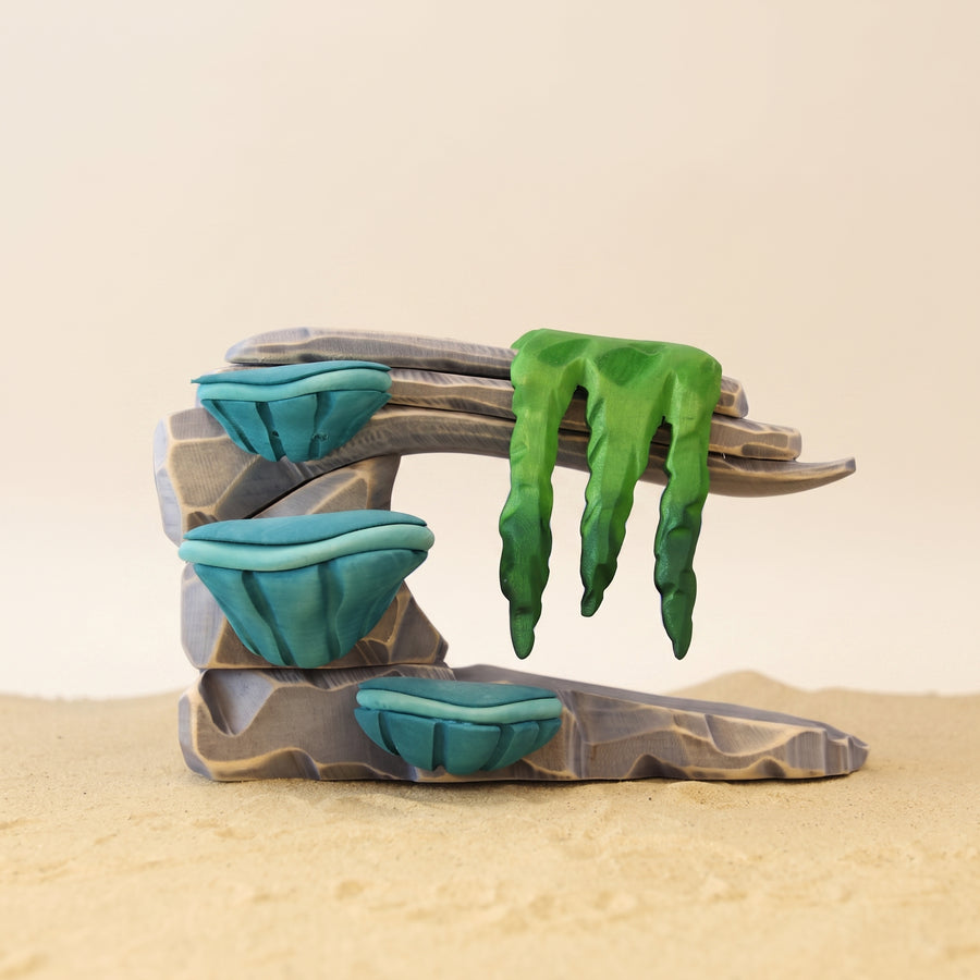 Wooden coral ledge in gray with turquoise coral cups growing from it at three heights