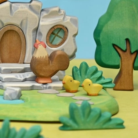 Wooden rooster shown in profile, hand-painted in brown and cream