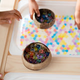 Q Toys patterned coconut rice bowls holding colored water beads on a sensory tray · view 2