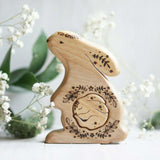 Hand-carved wooden bunny pregnancy announcement puzzle with a baby tucked inside the belly, by Tiny Fox Hole · view 1