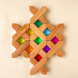 Bauspiel X-Blocks built into a flat pattern framing colored lucent cubes · view 2