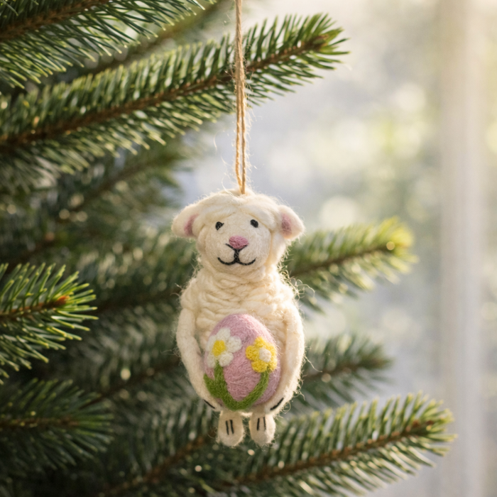 Handmade felt Easter lamb ornament holding a pastel egg