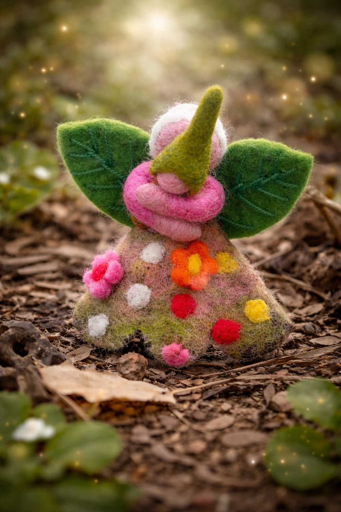 Felted fairy figurine with floral dress on a natural background