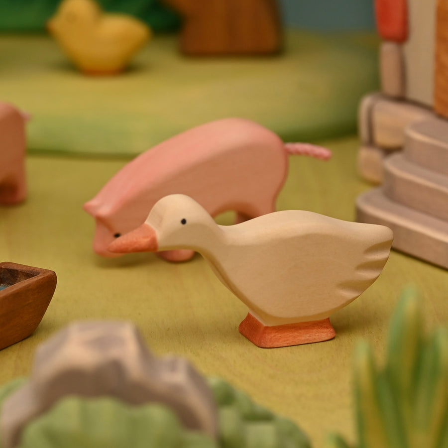 Wooden goose shown from the side, carved from linden wood with a smooth painted finish