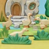 Wooden goose with head raised, shown in profile on a plain background · view 2