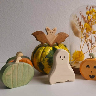 Wooden green pumpkin on a plain background, sized for small hands