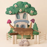 Second view of the wooden fairy house showing the carved base and garden · view 2