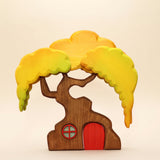 Wooden treehouse with a yellow canopy, a round window, and a red door that lifts out of the trunk · view 1