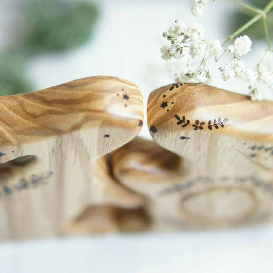 Hand-carved wooden bunny family announcement puzzle, two grown bunnies and a baby tucked into the belly, by Tiny Fox Hole