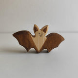 Juharka wooden bat with wings spread wide and the grain left bare across the wings · view 1