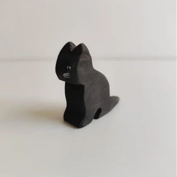 Juharka wooden black cat sitting upright with its tail curled around its feet