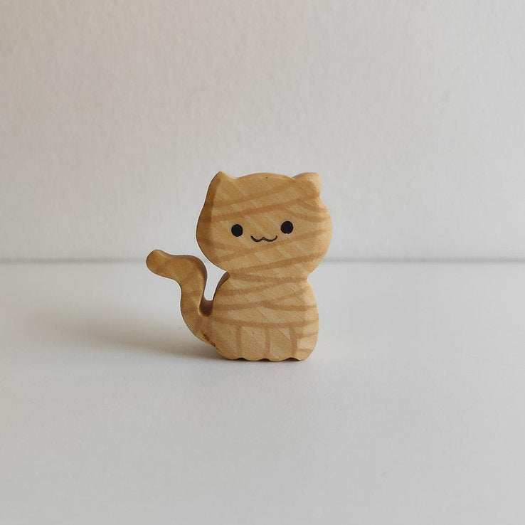 Juharka wooden mummy cat wrapped in carved bandages with one paw raised