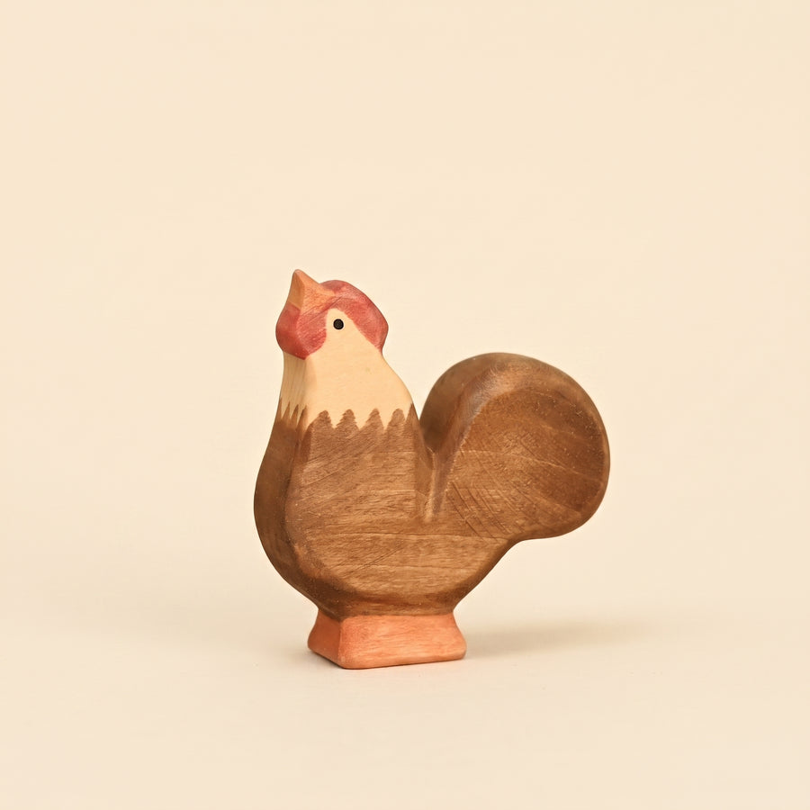 Mako Toys wooden rooster with a red comb and upright tail, standing on a painted base