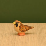 Hand-painted wooden sparrow shown from the side, small enough to perch on a fence rail or roof · view 3
