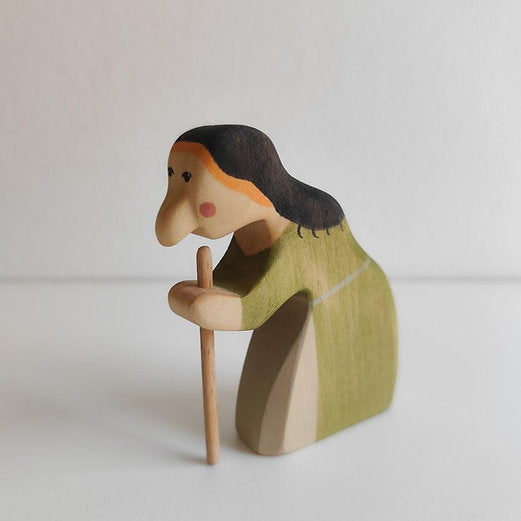 Hand-carved maple witch shown in profile, holding a removable wooden walking stick
