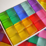Close-up of 20 Bauspiel Lucent Cubes in bright colors in their box · view 1